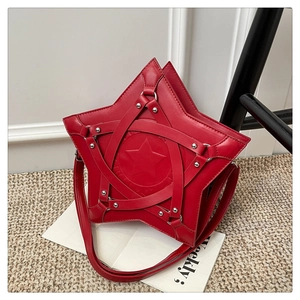 Detail of red star-shaped handbag with silver metal rivets and leather crisscross straps