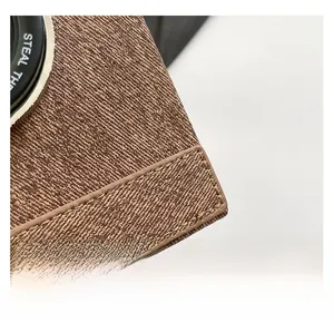 Detailed macro view of the premium textured brown faux leather and precision stitching