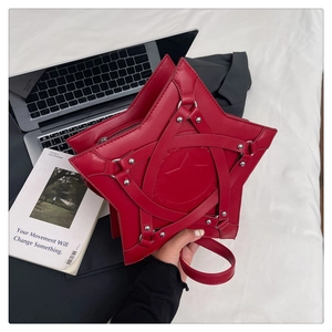 Top view of red star-shaped handbag with silver rivets and matte leather texture