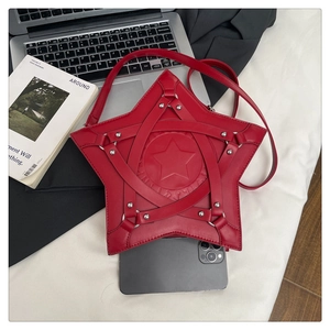 Red star-shaped shoulder bag size comparison with a smartphone and punk rivet details