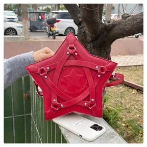 Close-up of red star-shaped crossbody bag featuring punk studs and unique lacing detail