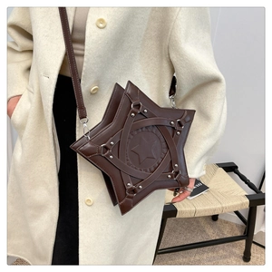 Detailed view of dark brown star-shaped crossbody bag with rivet accents and star embossing