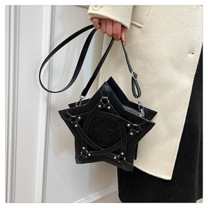 Close-up of star-shaped leather crossbody bag with silver rivets and buckle straps