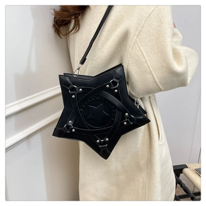 Star-shaped black crossbody bag with silver rivet details shown on a model