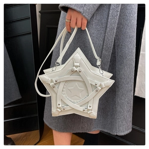 Detail of white star-shaped shoulder bag featuring silver rivets and cross leather straps