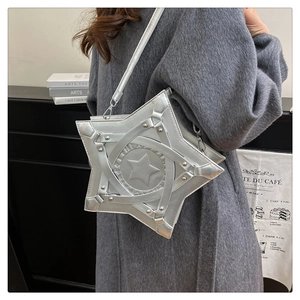 Close-up of silver star-shaped crossbody bag with metallic finish and rivet details