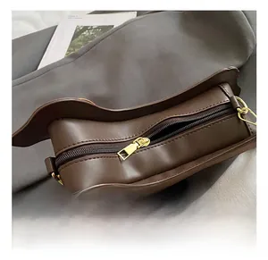 Detail of dachshund bag golden zipper closure and wavy edge on dark brown leather