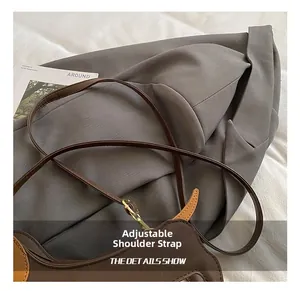 Detail of adjustable shoulder strap on dark brown pebbled leather dachshund bag