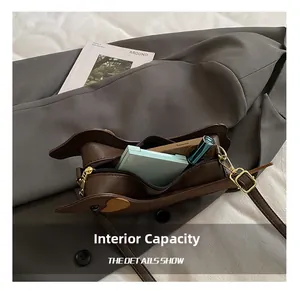 Detail of dachshund bag interior capacity holding phone, lipstick and cushion compact
