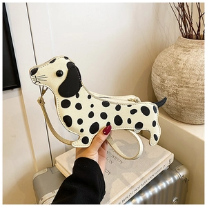 Macro detail of dachshund dog bag with black polka dots and leather shoulder strap