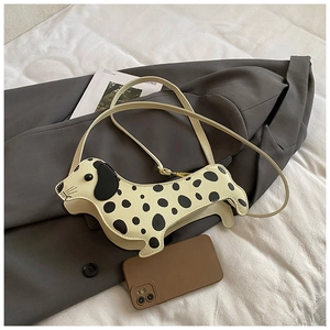 Mini dachshund-shaped spotted shoulder bag shown next to a smartphone for size reference