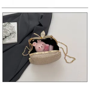 Detail of apple shaped gold glitter clutch bag showing capacity for lipstick and makeup
