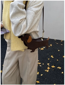 Detailed view of creative sausage dog shoulder bag with brown faux leather texture