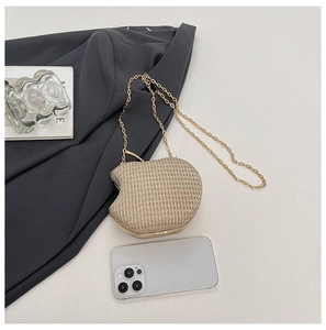 Detailed macro view of apple shaped gold clutch bag with glitter texture and chain