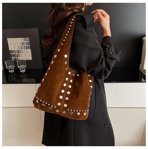 Détail du sac à bandoulière en daim marron vintage avec rivets argentés polis