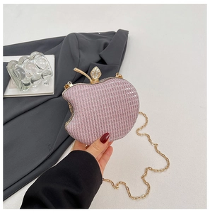 Detailed view of pink glitter apple-shaped evening bag with diamond leaf clasp and gold chain