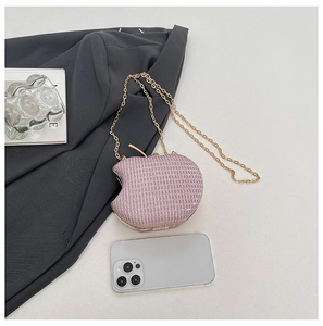 Detail of apple-shaped party clutch with pink rhinestones and gold chain strap