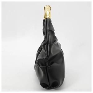 Detail view of black pleated leather hobo bag with sleek gold metallic handle design