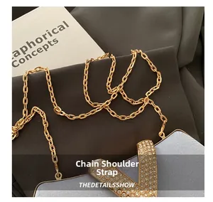 Detail shot of the sparkling rhinestone V-shaped hardware and elegant gold chain strap