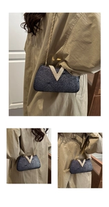 Detail of dark grey rhinestone evening bag with V-shaped gold metal trim and chain strap
