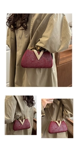 Detail of burgundy evening bag featuring a radiant texture and V-shaped rhinestone buckle