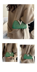 Close-up of luxury green evening clutch bag with sparkling texture and diamond V buckle