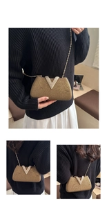 Detailed macro of gold evening bag featuring sparkling rhinestone V-shaped decoration