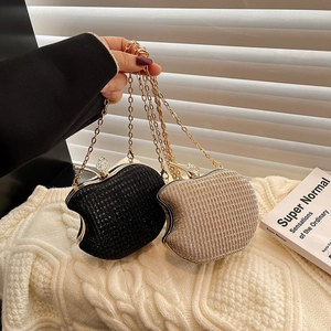 Fashionable apple-shaped acrylic evening clutch bags in black and gold with diamond leaf clasp