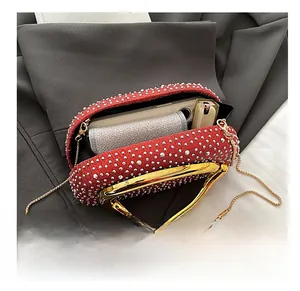 Detail view showing red rhinestone evening bag interior space with gold chain and handle