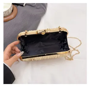 Detail of the champagne gold evening clutch showing black lining and gold chain strap