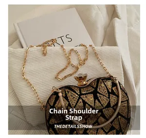 Detail of evening bag showing gold sequins on black suede with crystal clasp and chain