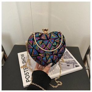 Detail of heart-shaped sequin evening bag with colorful geometric patterns and gold chain