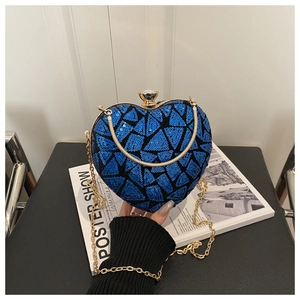Detail of heart-shaped blue sequin evening bag with gold chain and rhinestone clasp