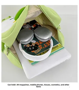 Detail view of the large capacity green apple-shaped bag showing laptop and A4 magazine inside