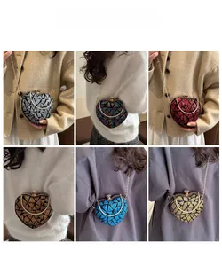 Sequin heart-shaped evening bags in multiple colors shown with metal chain straps