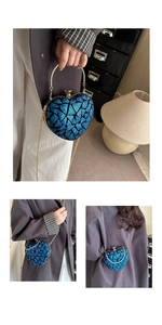 Detail of royal blue heart-shaped sequin clutch with gold circular handle and chain