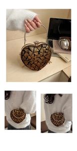 Detail of sequined heart evening bag with crystal clasp and gold chain strap