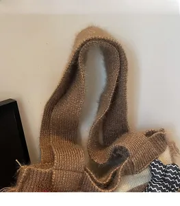 Close-up of soft brown mohair woven shoulder strap on a spacious knit tote bag