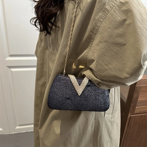 Elegant evening clutch bag with sparkling V-shaped rhinestone buckle and gold chain strap