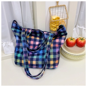 Close-up of colorful checkered wool tote bag with vibrant blue and pink plaid texture