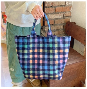 Detail shot of multicolor checkered wool tote bag with a vintage college style aesthetic
