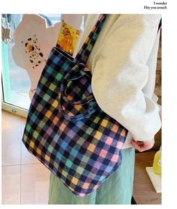 Detail of colorful plaid tweed tote bag with spacious interior and matching shoulder strap