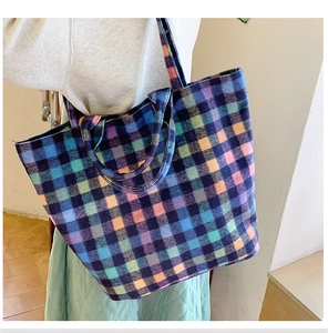 Detailed close-up of a large capacity checkered wool tote bag with colorful plaid pattern