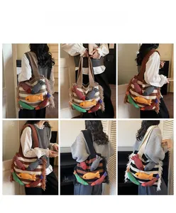 Detailed close-up showing woven tassel texture and colorful 3D fish decor on knit tote bag