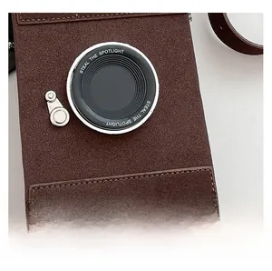 Detailed view of brown suede camera-shaped bag with lens feature and precise stitching