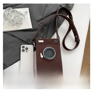 Detail view of retro camera shaped crossbody bag with vintage brown matte finish