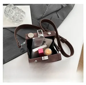 Interior view showing the capacity of the brown suede camera box bag for daily essentials