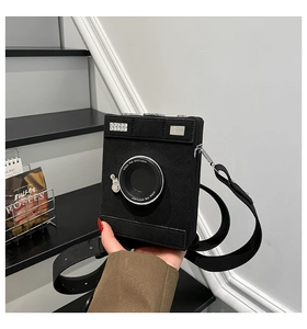 Detail of camera-shaped crossbody bag with Steal the Spotlight lettering and wide strap