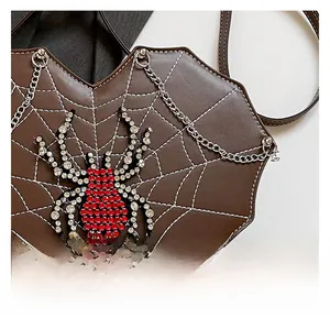 Close-up of gothic heart bag with rhinestone spider and embroidered web details