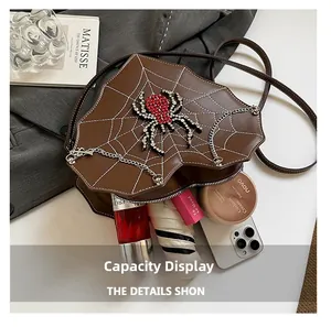 Interior view of brown spiderweb bag showing capacity for phone, lipstick and umbrella